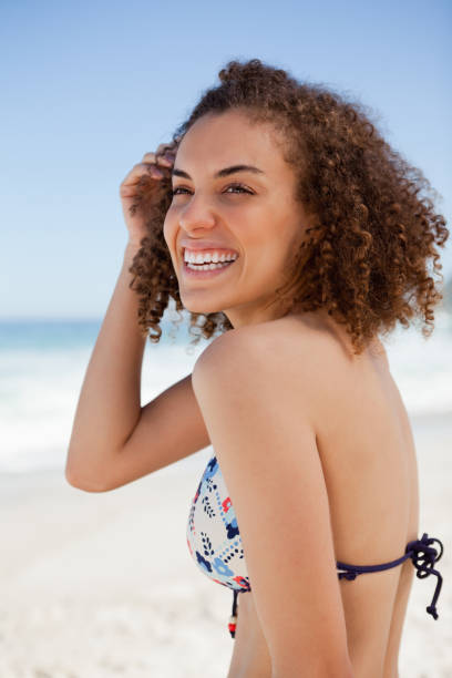 istock Young smiling woman looking towards the side while placing her hand next to her ear 842096550