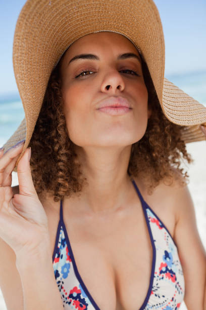istock Young attractive woman standing upright with puckered lips 842096676