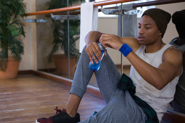 istock Tired male dancer holding water bottle at studio 842097248