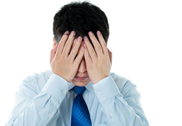istock Disappointed young businessman covering eyes with hands 842101140