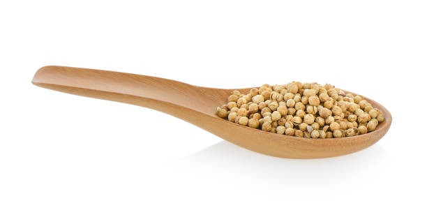 istock Coriander seeds in wood spoon on white background 842107492