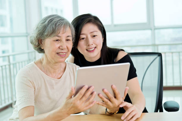 istock Granddaughter and grandmother using digital tablet 842108572