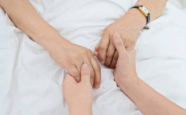 istock Young hands holding a senior woman's hands 842111634