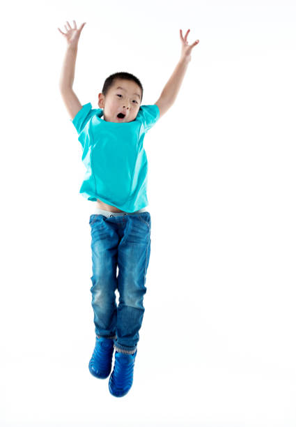 istock Young asian boy jumping against white background 842111832
