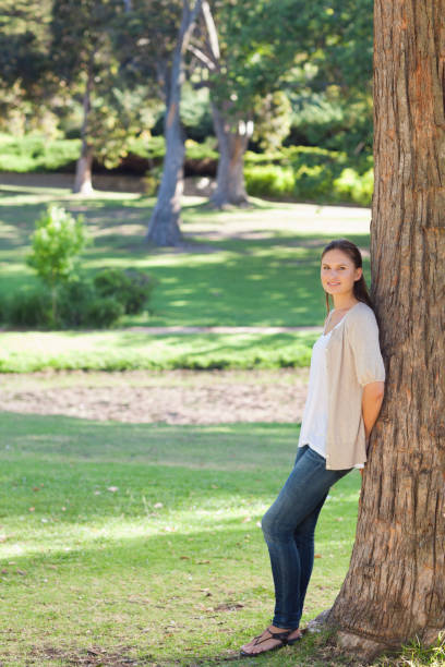 istock Woman in the countryside leaning against a tree 842119448