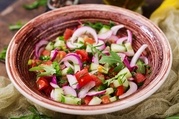 istock Tomato, cucumber and red onion salad with black pepper and arugula 842120026