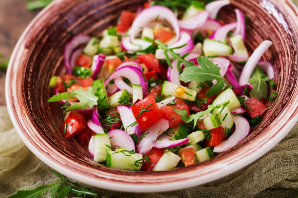 istock Tomato, cucumber and red onion salad with black pepper and arugula 842120042