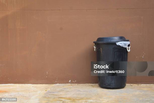 Black Bin And Wall On The Road Stock Photo - Download Image Now - Garbage Can, Black Color, Single Object