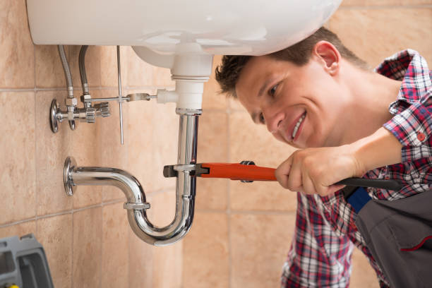 istock Plumber Fixing Sink Pipe With Adjustable Wrench 842125860