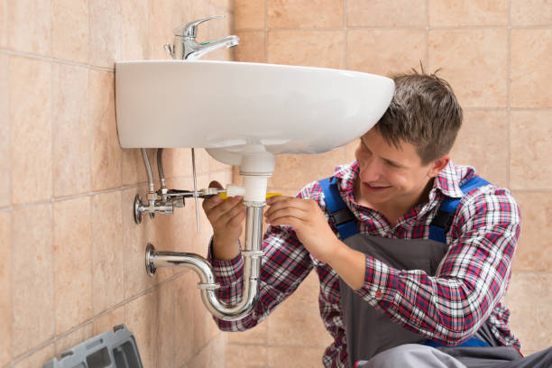 istock Smiling Plumber Repairing Sink 842125978