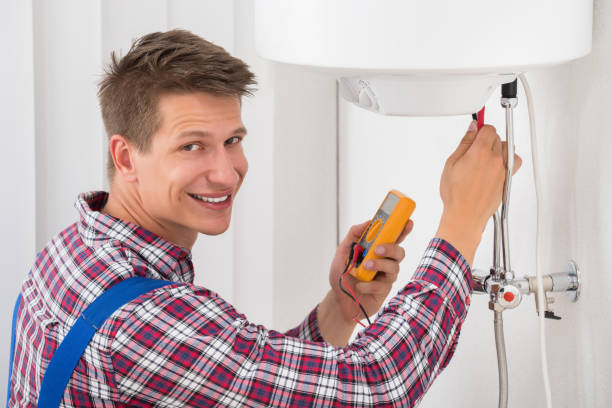 istock Male Plumber Examining Electric Boiler 842127362