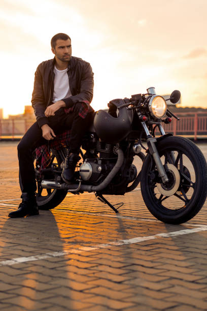 istock Brutal man sit on cafe racer custom motorbike. 842130502