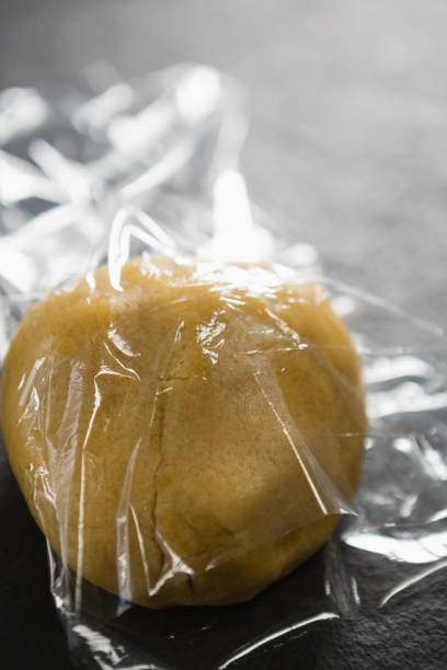 istock High angle view of dough in plastic wrap 842130646
