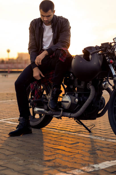 istock Brutal man sit on cafe racer custom motorbike. 842130680