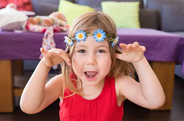 Photo of portrait of hippie little girl teasing with hands