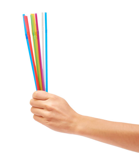 istock colorful straw in hand isolated on white background 842144382