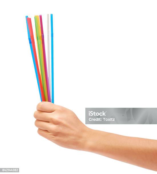 Colorful Straw In Hand Isolated On White Background Stock Photo - Download Image Now