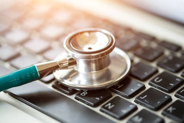 istock Medical stethoscope lying on laptop keyboard. 842145188