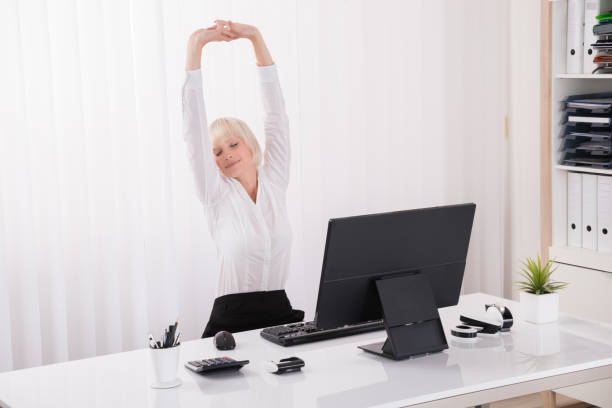 istock Businesswoman Stretching In Office 842145336