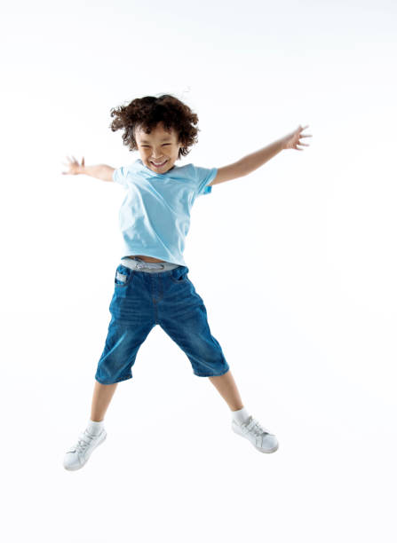 istock Little boy jumping isolated on white background 842147810
