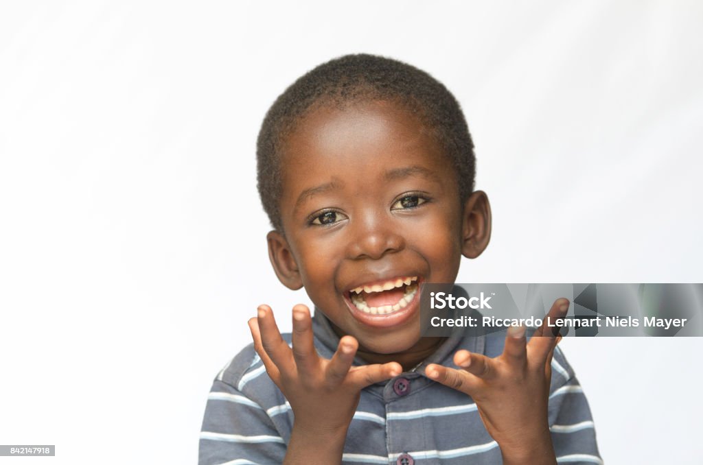 Surprised little African boy excited about getting a present isolated on white Isolated on white. Surprised Little African boy making a facial expression. Here he is acting surprised. Baby - Human Age Stock Photo