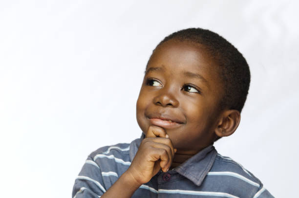 istock Little black boy thinking with hand on his chin 842147920