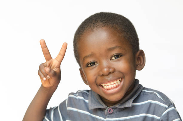 istock African black boy making peace sign for Africa (african ethnicity huge smile peace for the world) 842147946