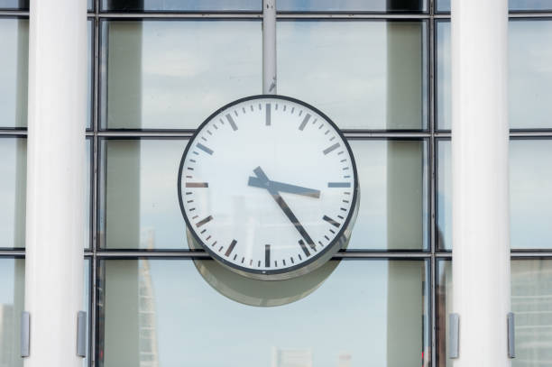 istock Clock in front of an office building 842152074