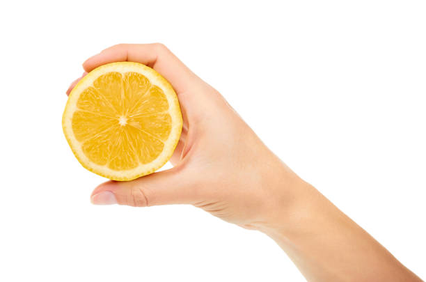 istock female hand holding lemon. Isolated on white background 842152350