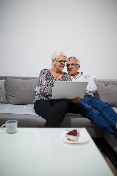 istock Senior couple websurfing on internet with laptop 842152394