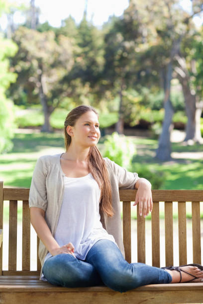 istock Woman relaxing on a park bench 842152632