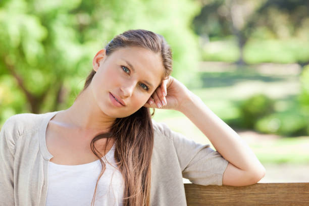 istock Thoughtful woman sitting on a park bench 842152668