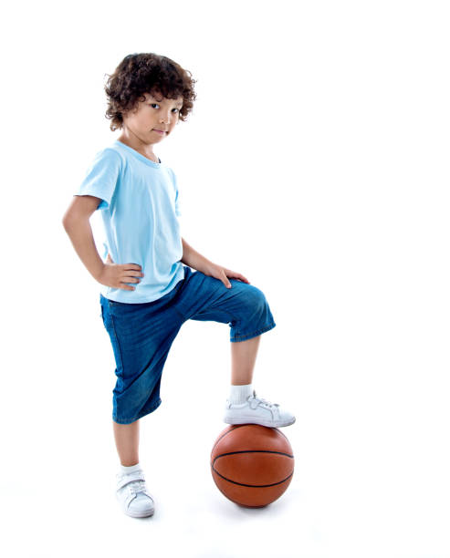 istock Young boy with a basketball against white background 842152724
