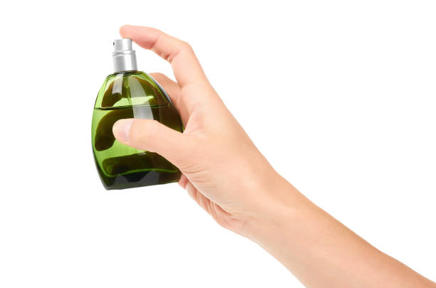 istock female hand holding perfume bottle. Isolated on white background 842153054