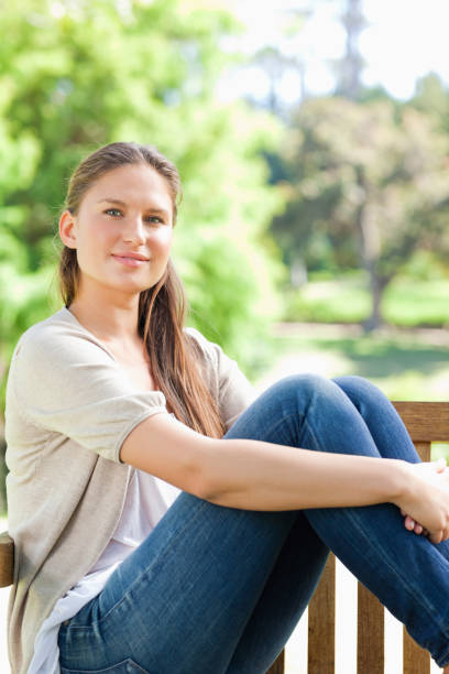 istock Woman relaxing on a bench in the park 842153370