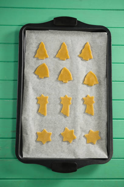istock Overhead view of various shape raw cookies in baking tray 842153390