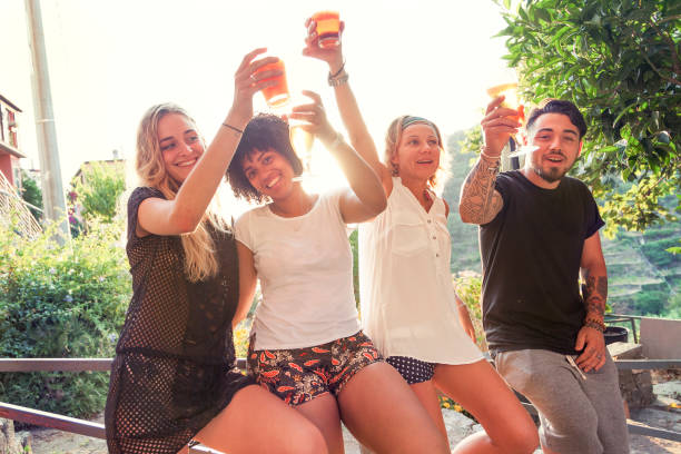 istock Group of young friends eating snacks and drinking beer 842155946