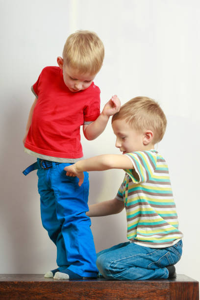 istock Two little boys siblings playing together on table 842160296