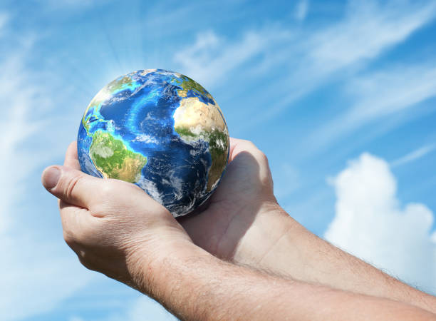 istock Globe in human hand against blue sky. Ecology concept. 842162992