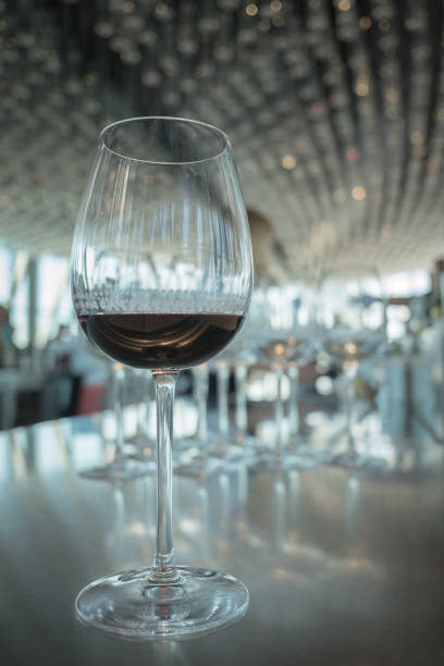 istock Wine glass with red wine on white bokeh background at luxury restaurant 842163278