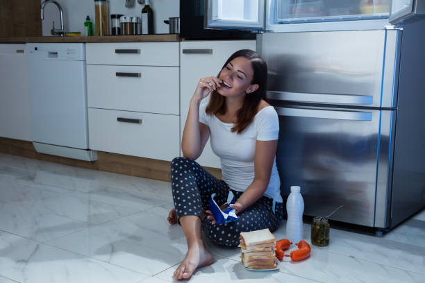 istock Woman Eating Chocolate In Kitchen 842163982