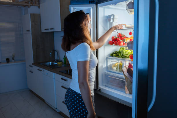 istock Woman Looking At Food In Refrigerator 842166528