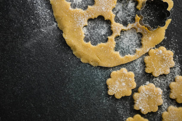 istock High angle view of flower shape cookies dough 842173486