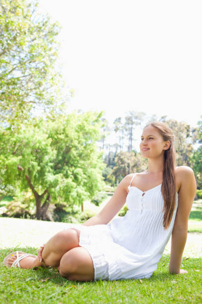 istock Woman relaxing on the grass in the park 842173848
