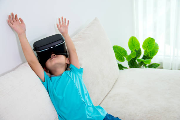 istock Little boy wearing virtual reality headset at home 842174234