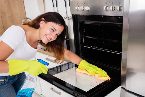 istock Woman Cleaning The Oven In Kitchen 842180136