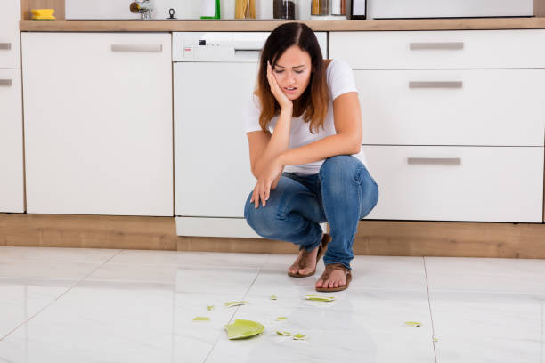 istock Unhappy Woman Looking At The Broken Plate On Floor 842183514