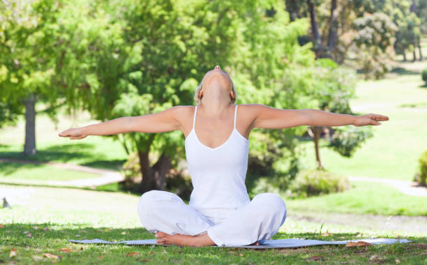 istock Woman on the lawn doing yoga exercises 842184982