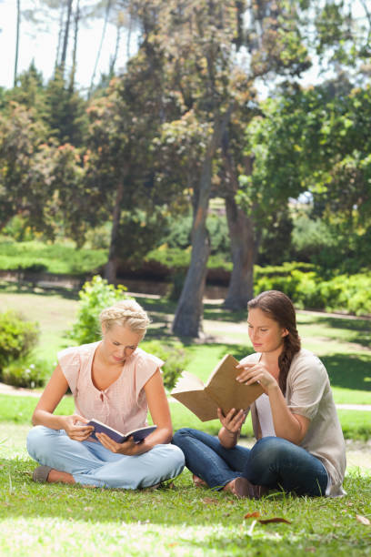 istock Friends reading their books in the park 842185388