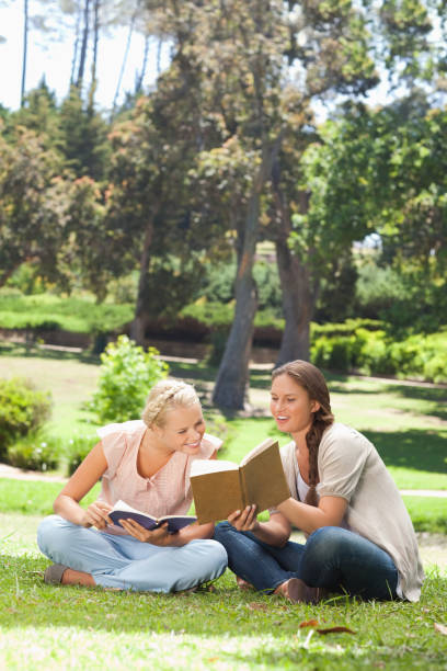 istock Woman showing her friend something in her book 842185406